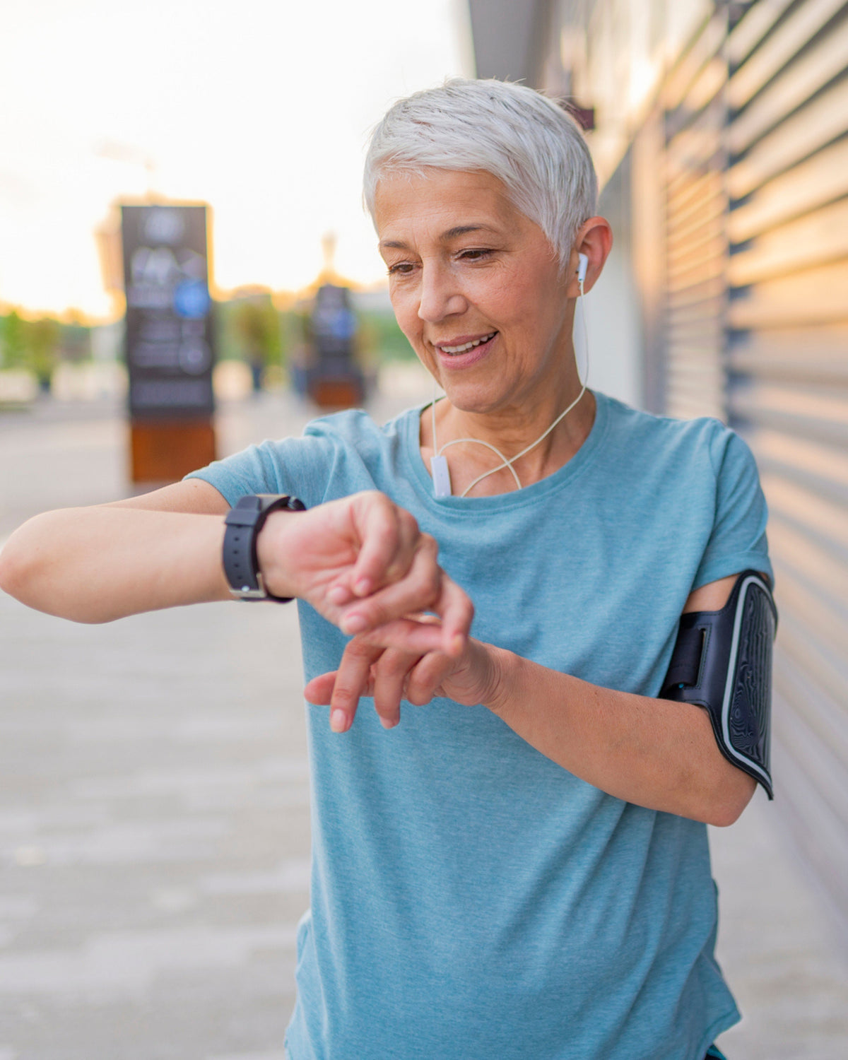 Woman checking watch tracking workout representing healthy heart with support of Aminocare BergaHeart.