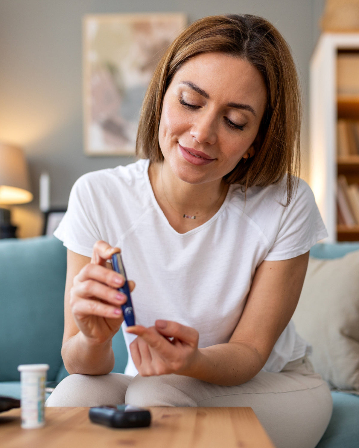 Woman checking glucose level representing AMINOCARE® Cinsulin supplement for balanced blood sugar.