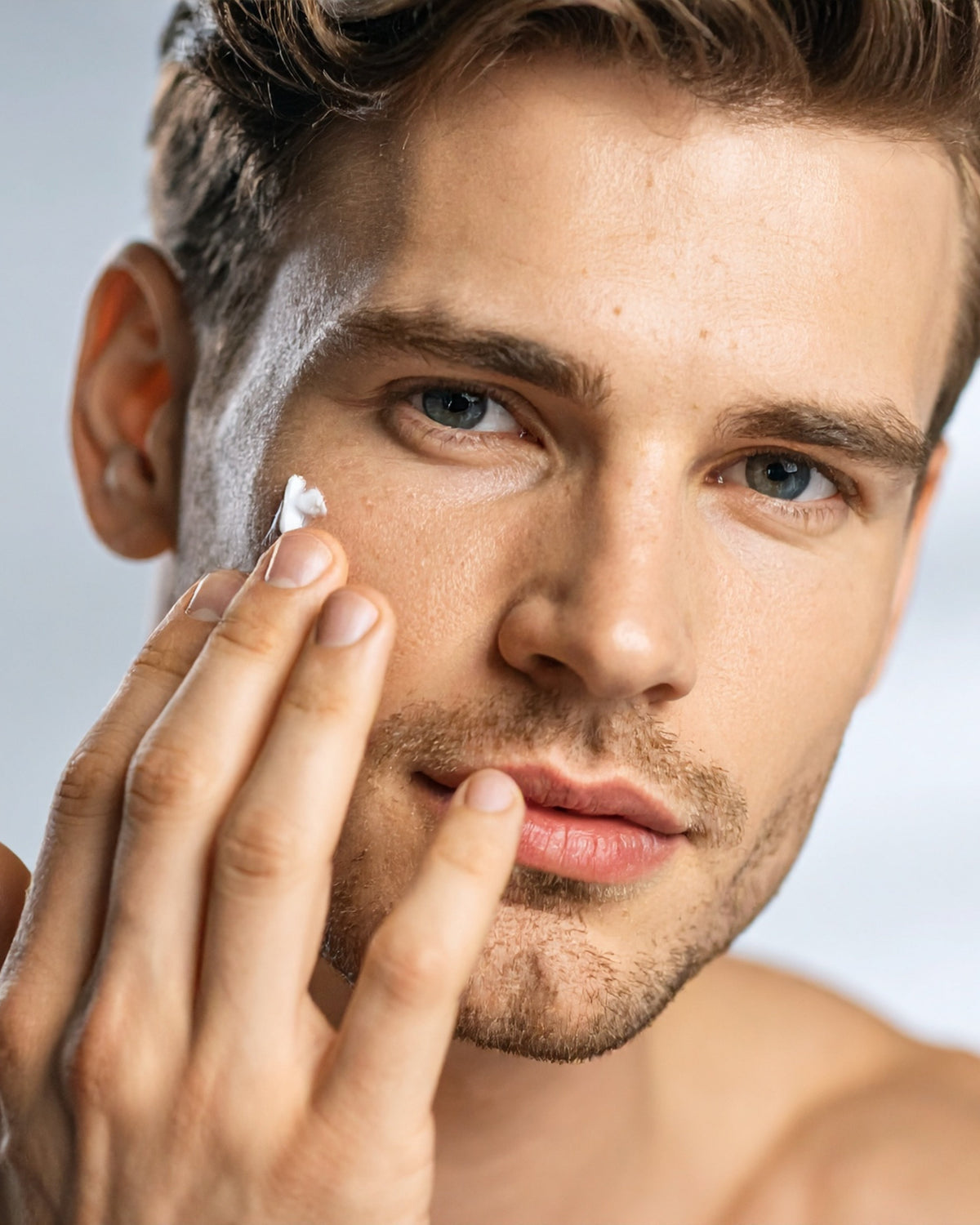 Man putting cream on his face representing Aminocare® cream.