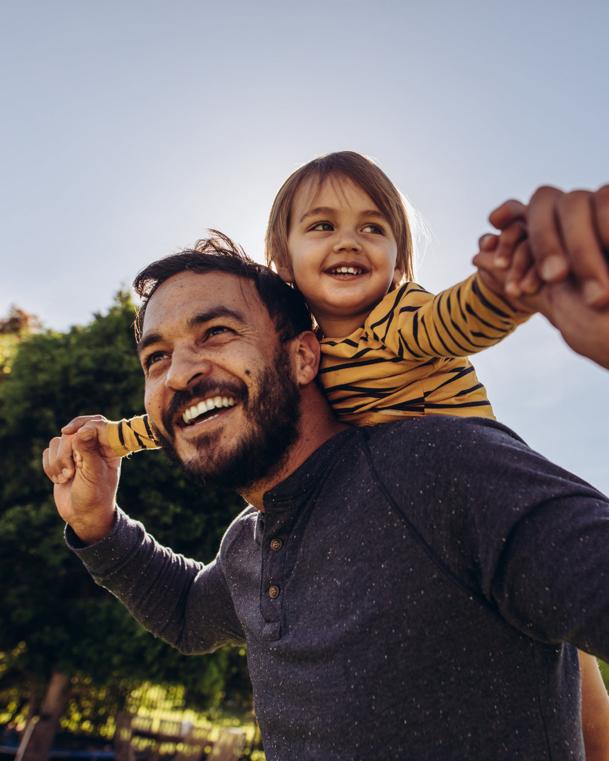Dad with toddler on back. Celebrating father's with Aminocare®  A10 to stay healthy and active. 