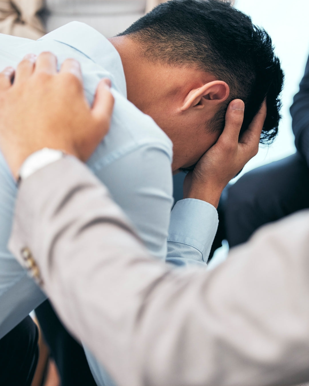 Man cupping his face with supportive hand on shoulder. The link between testosterone and mental health. Get balanced with Aminocare Daily Health Supplement for Men. 